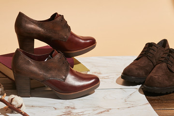 Stylish fashion shoes boots footwear concept on brown wooden background. Urban footwear advertising on wood