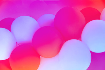 Trendy neon abstract background with color gradient from red pink fuchsia white blue purple combination pattern from air balloons on colorful glowing background