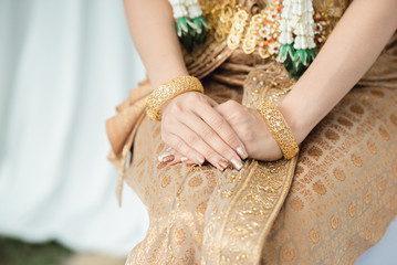The hand of a woman holding the hand that is getting married