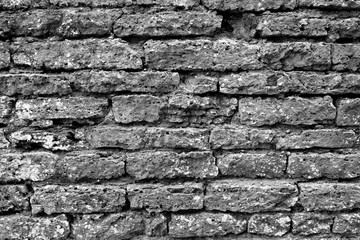 Old grungy brick wall texture in black and white.