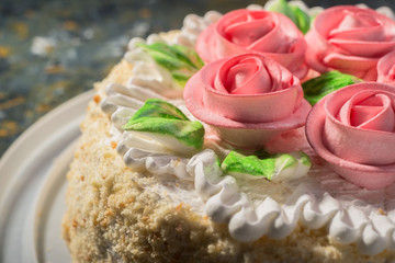 cake with roses close-up on a warm background. confectionery
