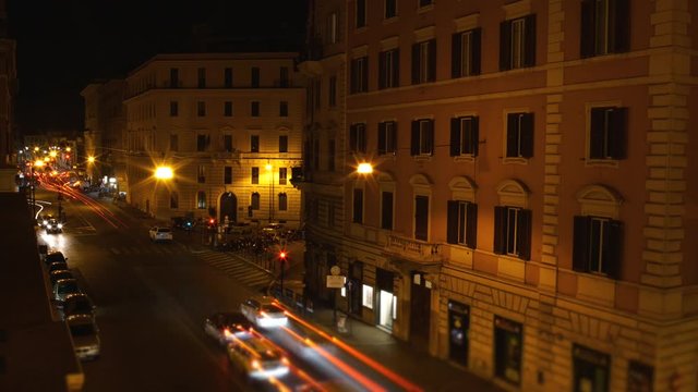 Overhead shot timelapse of a busy street full of cars at night in Rome, Italy. Vacation, holidays, travel in Europe.