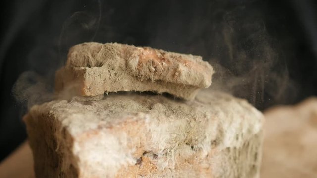 slice of bread falling on moldy bread, particles of mold slow motion, swirl, floating