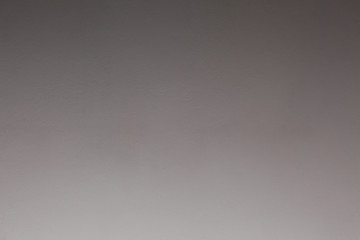 close uo on a plaster wall fading from light grey to dark gray