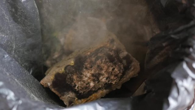 throwing moldy bread in the trash can, slow motion