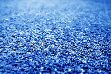 Artificial grass with blur effect in navy blue tone.