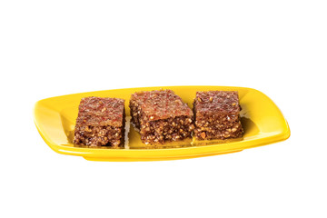 Pieces of Sheki halva on a plate isolated on white
