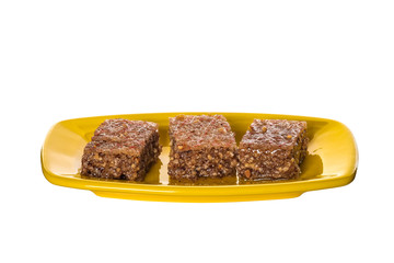 Pieces of Sheki halva on a plate isolated on white