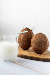 brown coconut with straw, tropical refreshing drink. Coconut milk