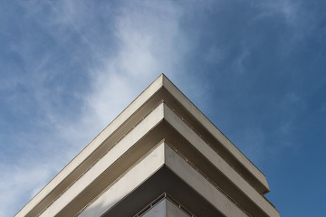 White triangular building under blue and cloudy sky
