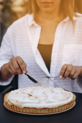 Tasty lemon meringue pie. Traditional french sweet pastry tart. Delicious, appetizing, homemade dessert with lemon cream. Copy space, closeup. Selective focus. Black background. Toned