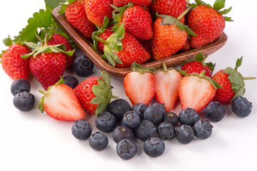 A bowl set of beautiful and delicious strawberry and blueberry isolated on white background, close up, copy space, clipping path, cut out.