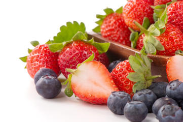 A bowl set of beautiful and delicious strawberry and blueberry isolated on white background, close up, copy space, clipping path, cut out.