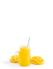 Fresh tropical mango juice with beautiful diced pulp and striped paper straw isolated on white background table, close up, cut out, clipping path.