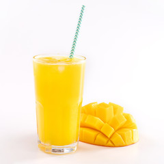 Fresh tropical mango juice with beautiful diced pulp and striped paper straw isolated on white background table, close up, cut out, clipping path.