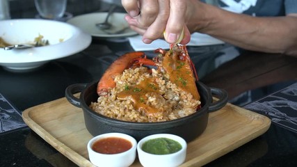 Squeezing lemon to lobster Spanish fired rice luxury delicious seafood meal