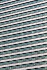 Glass windows and concrete walls in the daytime. Arcitectural fragment of modern building in Bangkok, Thailand.