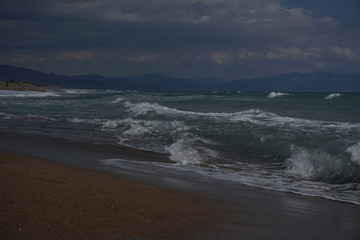 Fototapeta na wymiar Waves at the coast of the mediterranean sea in greece