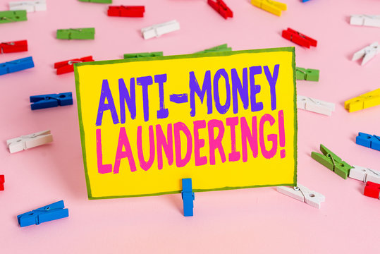 Word writing text Anti Money Laundering. Business photo showcasing regulations stop generating income through illegal actions Colored clothespin papers empty reminder pink floor background office pin