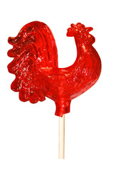 Caramel lollipop bright red very large sugar cockerel on a white background, a traditional children's treat © Valentina