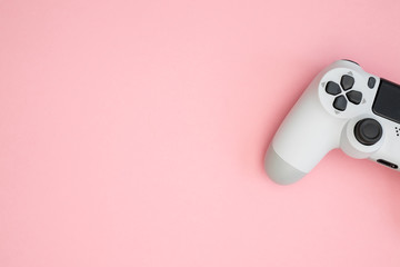 Video games white gaming controller isolated on pink color background top view