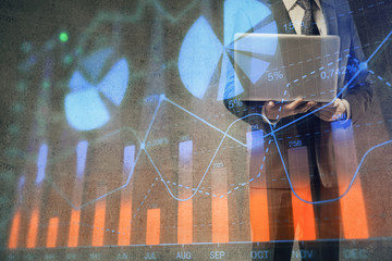 Forex graph with businessman working on laptop on background. Concept of hardworking. Multi exposure.