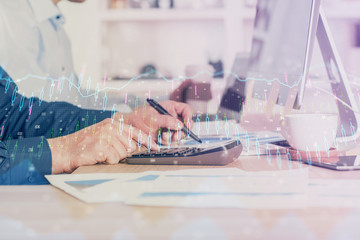 Forex graph with businessman working on computer in office on background. Concept of hardworking. Closeup. Multi exposure.
