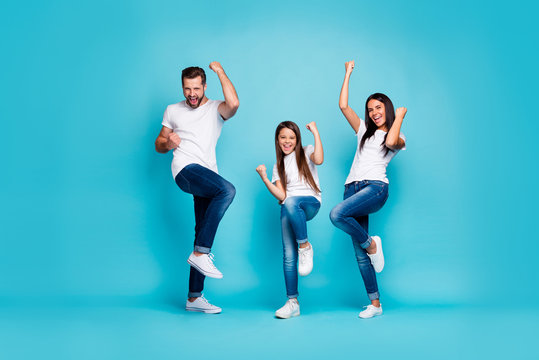 Full body photo of daddy mommy and small lady raising fists air rejoicing wear casual outfit isolated blue background