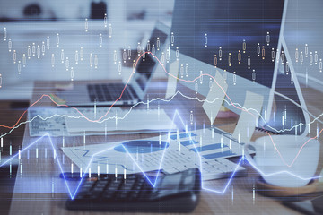 Double exposure of forex chart and work space with computer. Concept of international online...