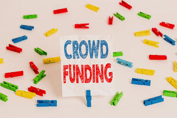 Text sign showing Crowd Funding. Business photo showcasing Fundraising Kickstarter Startup Pledge Platform Donations Colored clothespin papers empty reminder white floor background office