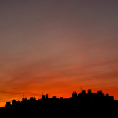 Fototapeta na wymiar Roofs of houses on a background of a beautiful sunset