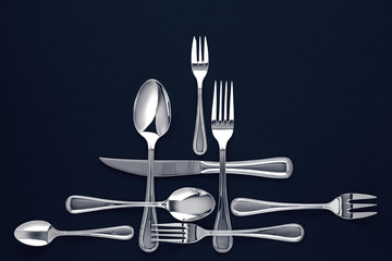 Stylish cutlery, on a dark blue background. View from above. Free space for text
