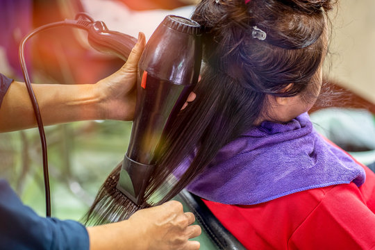Hairdresser using hair dryer in beauty salon. Concept cut salon..