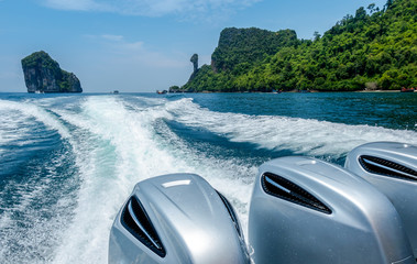 Splash wave water from Speed Boat's Engines with Full Speed Drive on blue sea with beautiful sky...