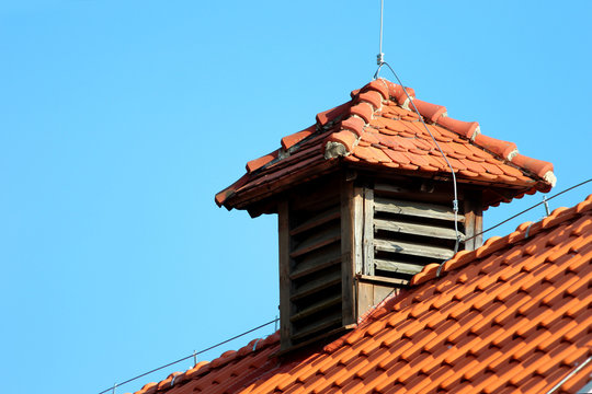 Ventilating chimney on a rooftop with lightning rod