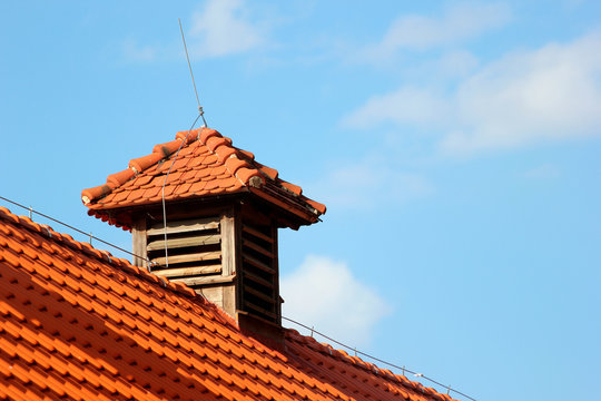 Ventilating window on a rooftop with lightning rod