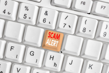 Writing note showing Scam Alert. Business concept for unsolicited email that claims the prospect of...