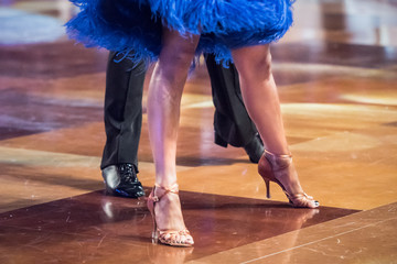 Legs of young dancers on the dance floor