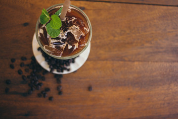 Iced latte coffee on wooden table in cafe