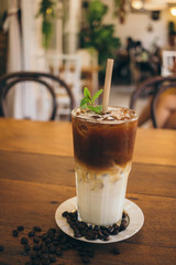Iced latte coffee on wooden table in cafe