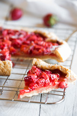 Homemade sweet strawberry cake with fresh strawberries on white wooden table
