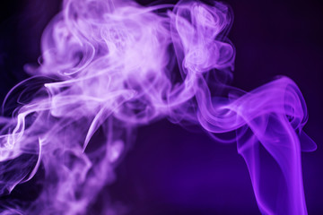 Smoke on a dark background in a bright trendy purple neon light. Minimalistic background concept.