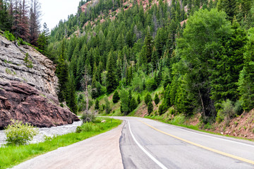 Road highway 133 in Redstone, Colorado during summer with empty street, raging river and green trees