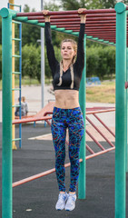 athletic girl doing exercises on the abs on the playground