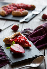 Homemade sweet strawberry cake with fresh strawberries on dark background