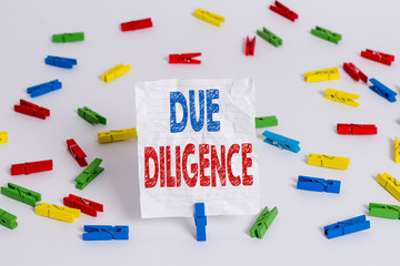 Text sign showing Due Diligence. Business photo showcasing Comprehensive Appraisal Voluntary Investigation Audit Colored clothespin papers empty reminder white floor background office
