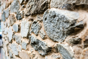 Old, different colors stone wall background texture close up. Selective focus - mage