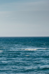 Obraz premium Blue sea with waves and cloudy sky background. Atlantic ocean. 