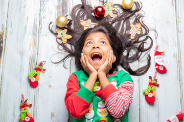 Cute cheerful smiling girl with decorated Christmas hair