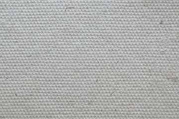 Textile background in gray. Empty porous surface with pile particles. Backdrop for decoration.